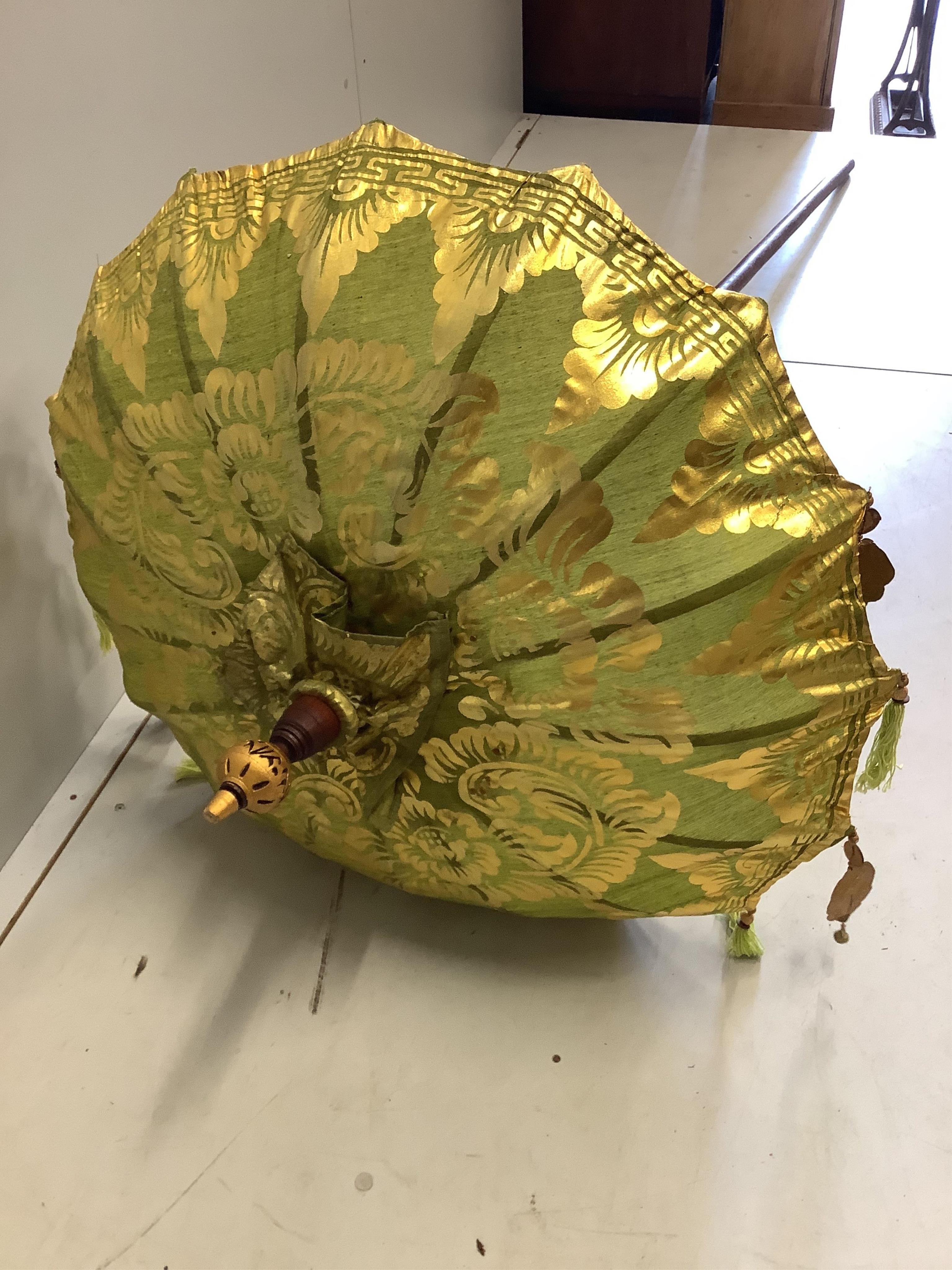 Two Indian parasols, larger approximately height 250cm. Condition - fair